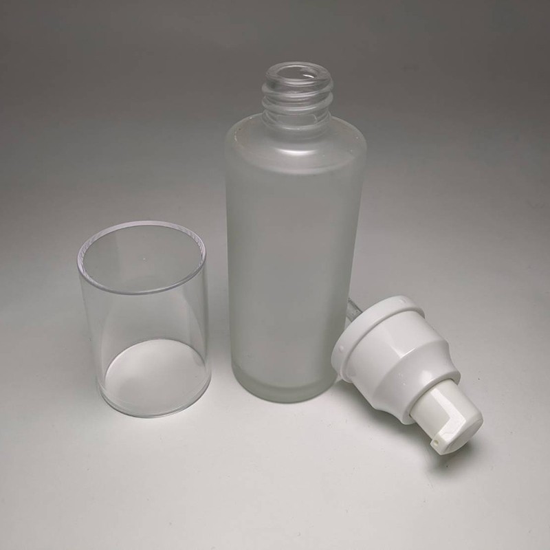 Fancy glass bottle packaging empty 50ml cylinder shape glass bottle customization spray color with lotion pump for facial skincare