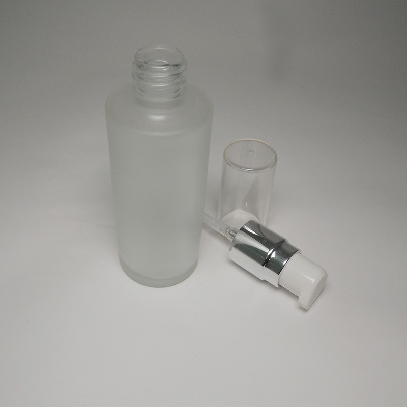 Facial lotion cream empty glass bottle packaging 50ml capacity cylinder shape custom logo and color transparent cap